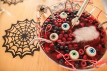 High angle view of Halloween dessert with berries and floating eyeballs — Stock Photo