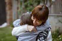 Mother and daughter hugging each other outdoors — Stock Photo