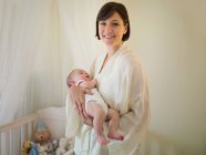 A mother holding a new born baby — Stock Photo
