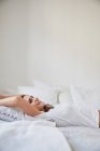 Oberflächenansicht der schönen jungen Frau liegend auf dem Bett — Stockfoto