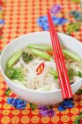 Bowl of noodle soup with chopsticks, close up — Stock Photo