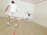 Man and woman playing squash — Stock Photo