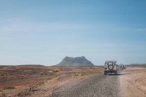 Jeeps dirigindo na paisagem empoeirada — Fotografia de Stock