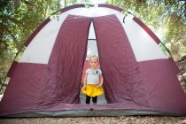 Young female toddler in tent doorway — Stock Photo