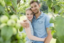 Mid adult couple with arms around each other — Stock Photo