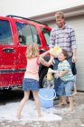 Family washing car together, selective focus — Stock Photo