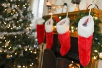 Christmas stockings on fireplace — Stock Photo