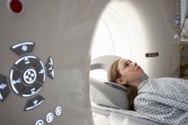 Elementary age girl going into CT scanner in hospital — Stock Photo