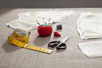 Sewing pattern, pin cushion and tape on table — Stock Photo
