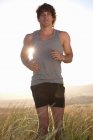 Man jogging in tall grass — Stock Photo