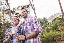 Two male hikers having coffee in forest, Deer Park, Cape Town, South Africa — Stock Photo