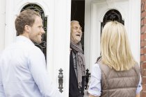 Father opening front door laughing — Stock Photo
