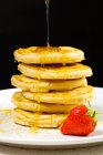 Honey pouring on pancakes — Stock Photo