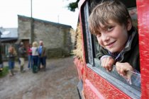 Boy looking out of 4x4 landrover window — Stock Photo
