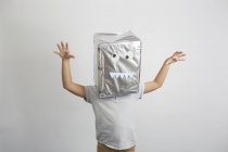 Boy with silver box on head, funny face on box — Stock Photo