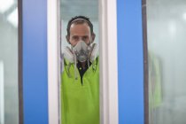 Portrait of carpenter in spray painting workshop doorway — Stock Photo