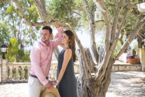 Couple by olive tree in boutique hotel garden, Majorca, Spain — Stock Photo
