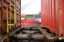 Train passing shipping containers — Stock Photo