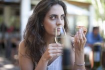 Young woman smelling wine at vineyard bar — Stock Photo