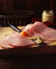 Ham slices with knife and wholegrain mustard — Stock Photo