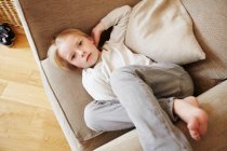 Young girl lying in armchair, portrait — Stock Photo