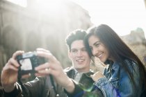 Young couple photographing themselves — Stock Photo