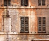 Wooden shutters on abandoned building — Stock Photo