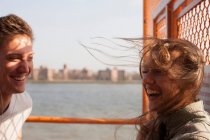 Coppia giovane su un traghetto, vento che soffia capelli — Foto stock