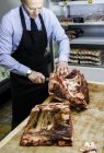 Butcher preparing beef joint — Stock Photo