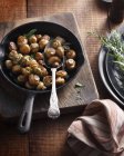 Tarragon button mushrooms in frying pan — Stock Photo