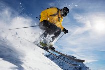 Male skiing over mountain ridge — Stock Photo