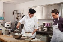 Chefs preparing food in commercial kitchen — Stock Photo