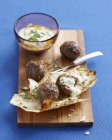 Lebanese meatballs on chopping board with dipping sauce — Stock Photo