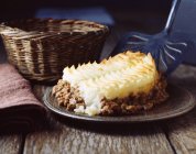 Homemade cottage pie on plate with spatula — Stock Photo