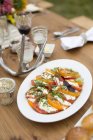 Prepared caprese salad dish on dinner table — Stock Photo
