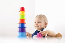 Little boy playing with stacking cups — Stock Photo
