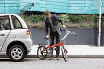 Man with folding bicycle — Stock Photo