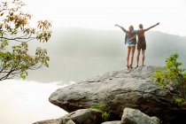 Young women looking out over lake — Stock Photo
