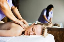 Woman having back massage in spa — Stock Photo