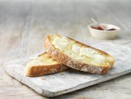 Schmelzende Butter auf warmem Toast und Erdbeermarmelade — Stockfoto