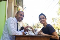 Couple holding hands at outdoor cafe — Stock Photo
