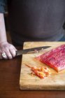 Man making gravlax on wooden board, close-up partial view — Stock Photo
