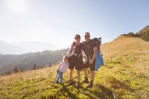 Family hiking together on hillside — Stock Photo