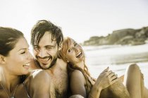Three mid adult friends sitting together on beach, Cape Town, South Africa — Stock Photo