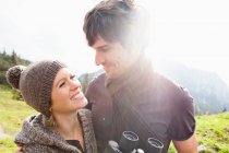 Couple with binoculars on mountain — Stock Photo