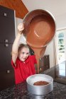 Ragazza versando torta mix in torta di latta — Foto stock