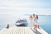 Young adults on pier with boat, Gavle, Sweden — Stock Photo