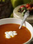 Close up shot of tomato soup portion with fresh cream — Stock Photo