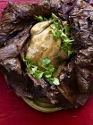 Still life of Beggars Chicken wrapped in lotus leaf with coriander garnish — Stock Photo