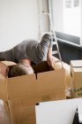 Man searching cardboard boxes — Stock Photo